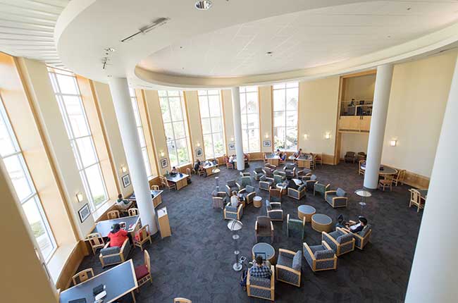 rotunda with armchairs full of people studying