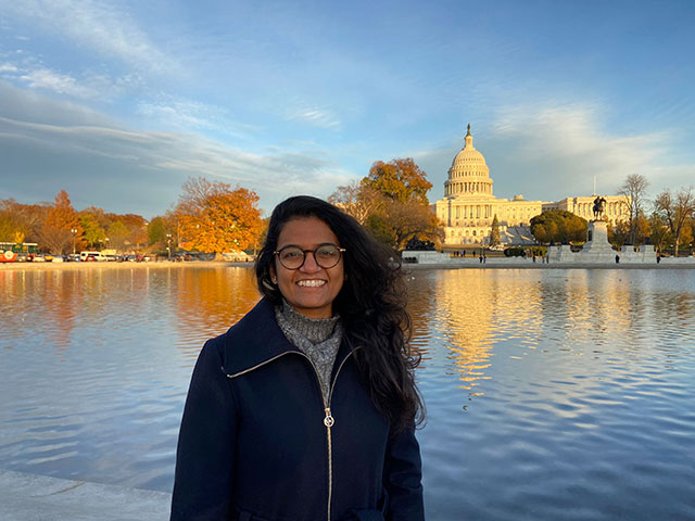 Aparna in front of the Capitol building