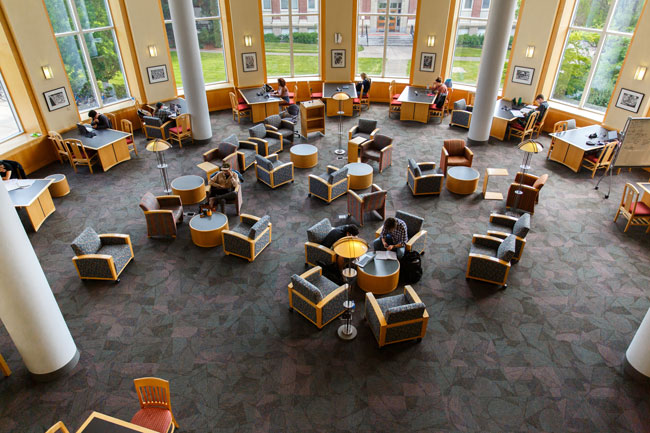 people studying in armchair in a sunny rotunda