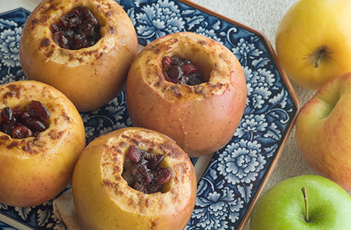 baked cored apples on plate with blue flowers 