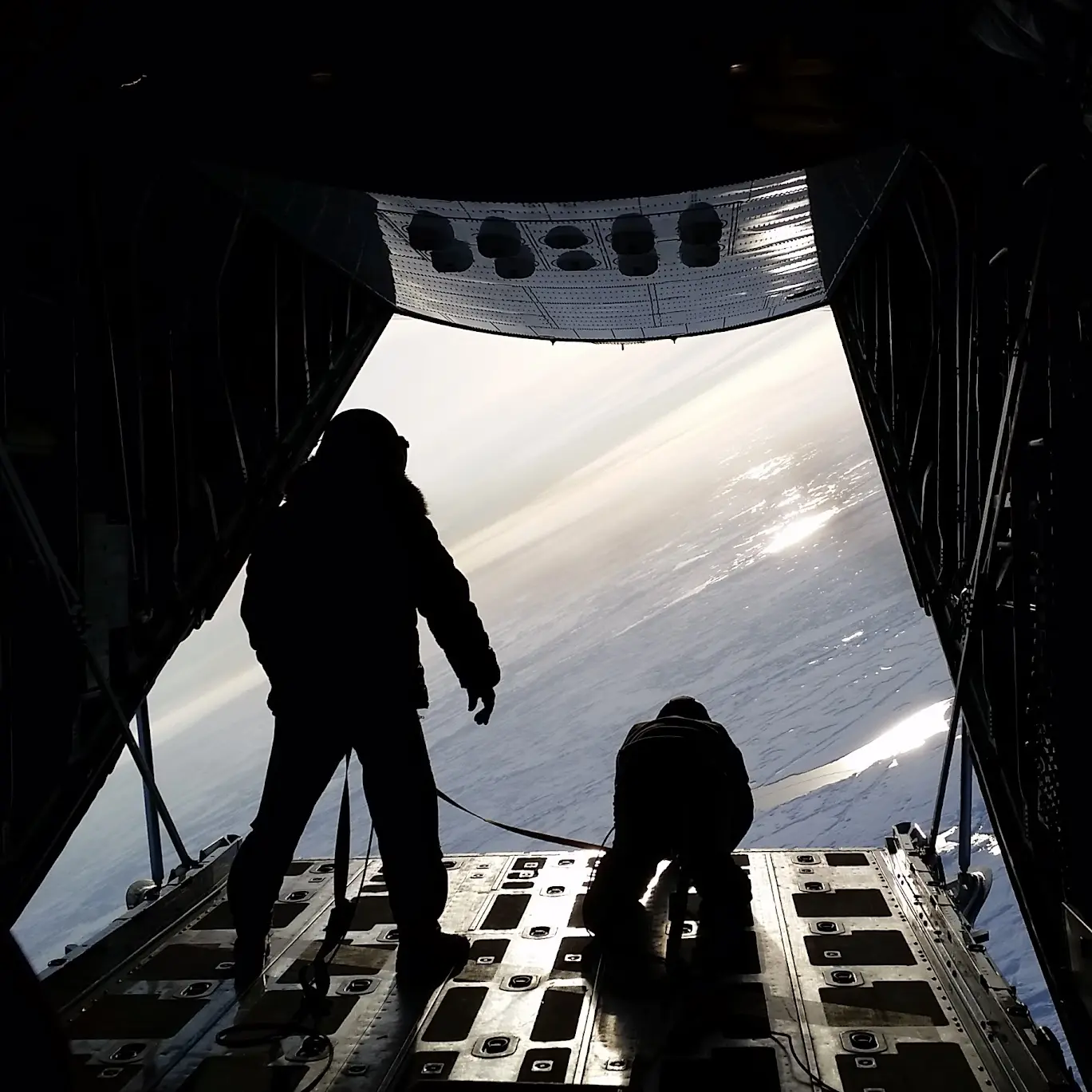 Steenson and another person standing at the exit door of an airplane that looks over ice