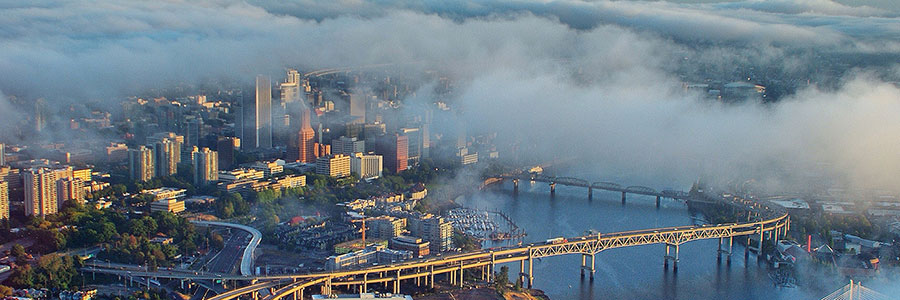 aerial view of Portland, the downtown skyscrapers peaking out of clouds